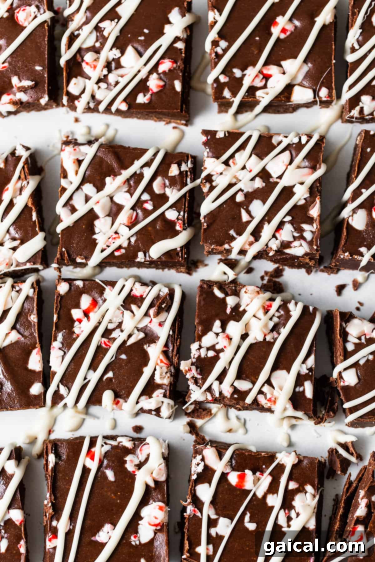 Arctic Peppermint Fudge 8 Beautifully garnished peppermint freezer fudge pieces with white chocolate drizzle and crushed peppermint on top.
