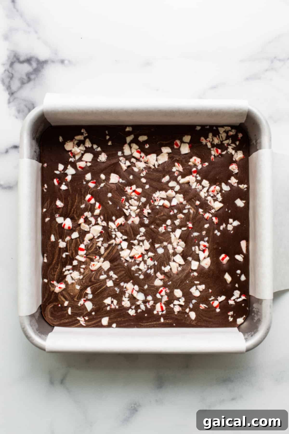 Arctic Peppermint Fudge 6 Freezer fudge block adorned with vibrant crushed peppermints on top, ready for slicing.