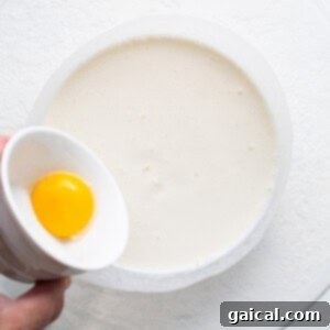 Adding an egg to the melted ice cream.