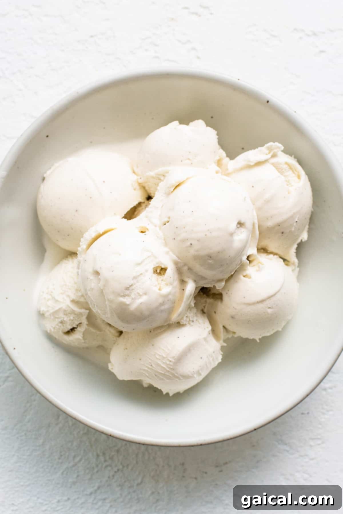 Spiced Eggnog Crème Brûlée 3 A bowl of creamy eggnog ice cream, highlighting the main ingredient for this holiday dessert.
