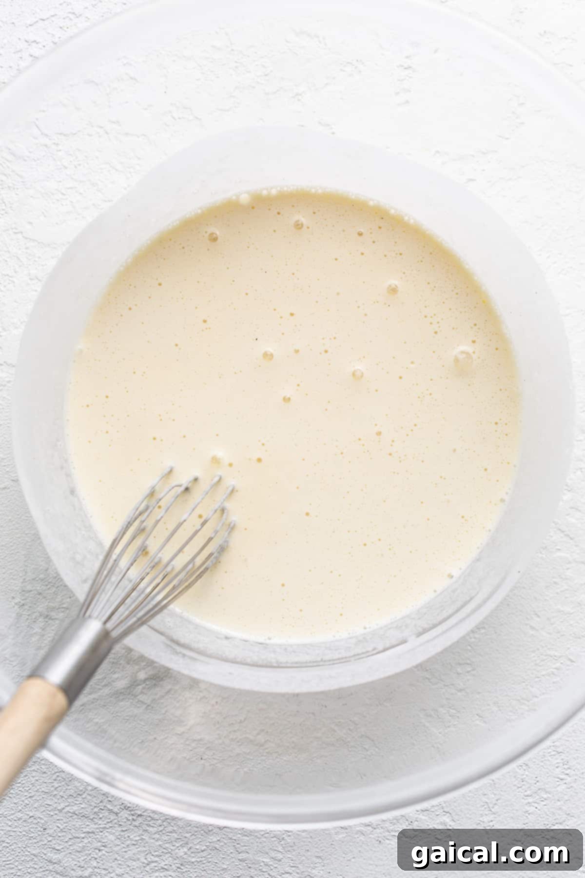 Spiced Eggnog Crème Brûlée 4 Melted eggnog ice cream in a bowl, prepared for mixing with other ingredients.