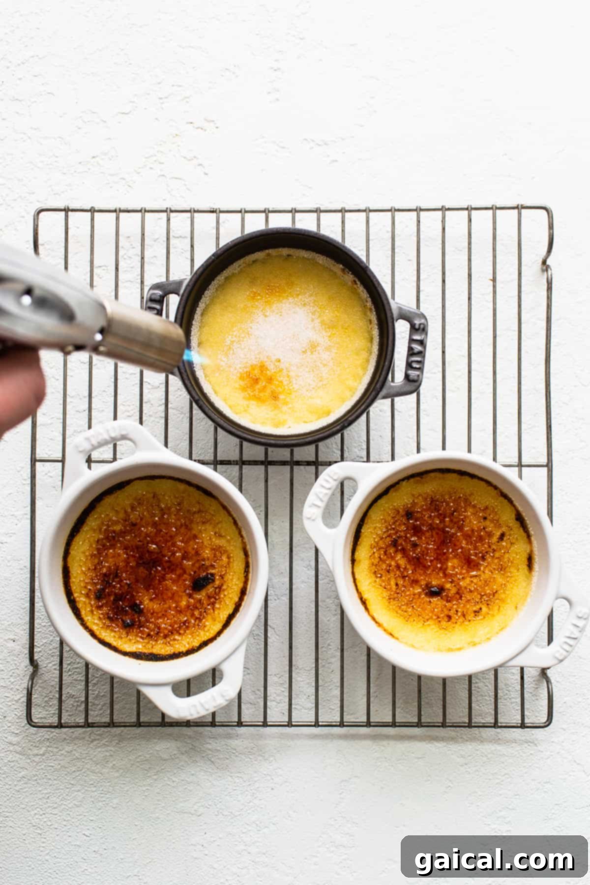 Spiced Eggnog Crème Brûlée 7 A kitchen torch caramelizing the sugar on top of an Eggnog Crème Brûlée.