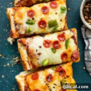 Close-up of a French bread pizza slice, highlighting the melted cheese and crisp toppings.