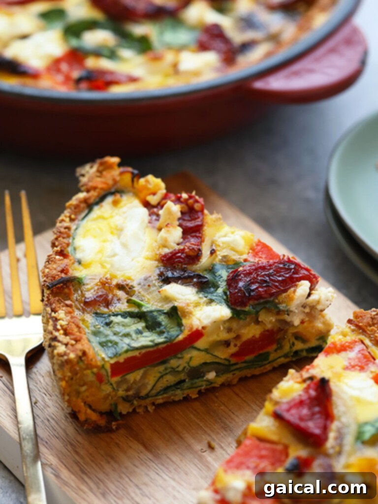 15+ Creative Egg Breakfasts to Kickstart Your Day 13 A perfect slice of sweet potato crust quiche, showcasing the healthy crust and flavorful filling, on a rustic cutting board with a fork.