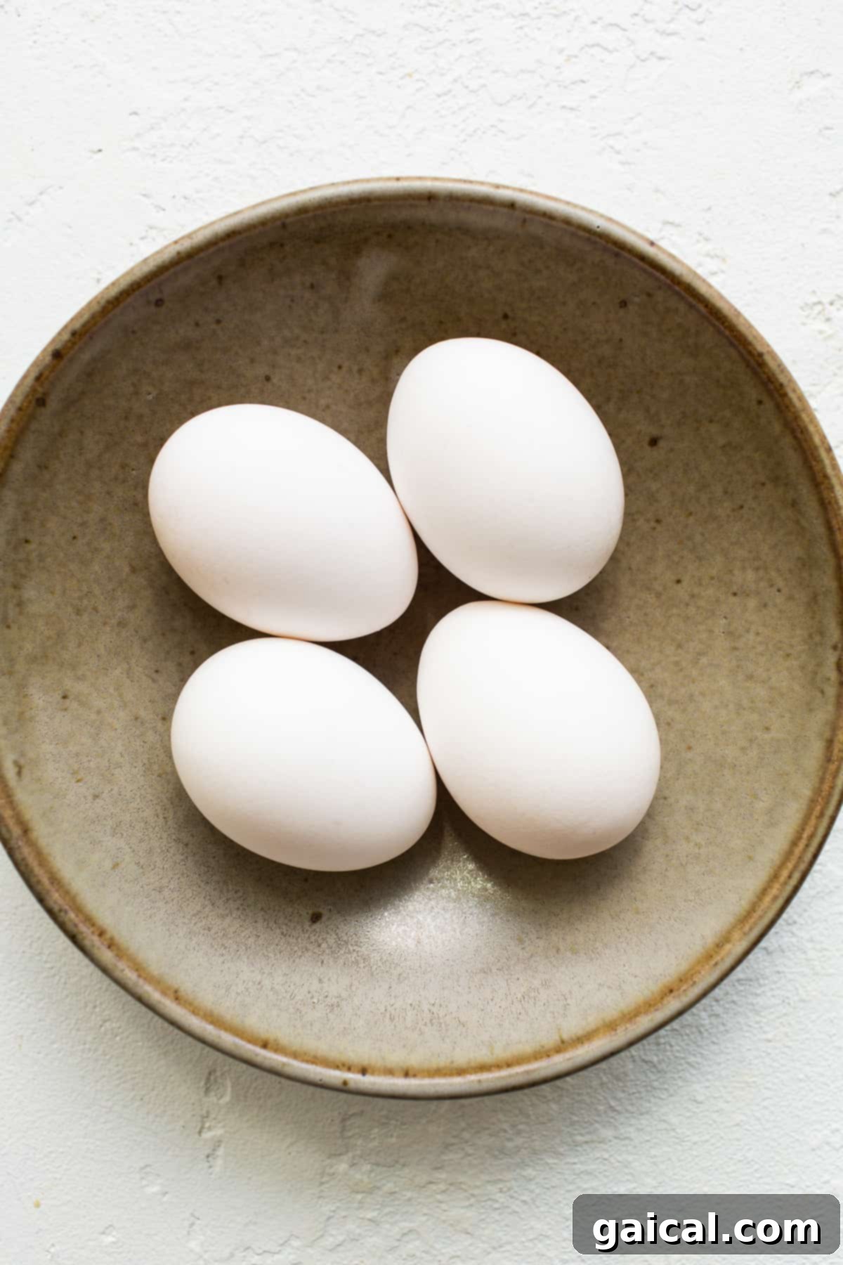 Liquid Gold Breakfast 3 Fresh eggs in a bowl, ready for cooking.