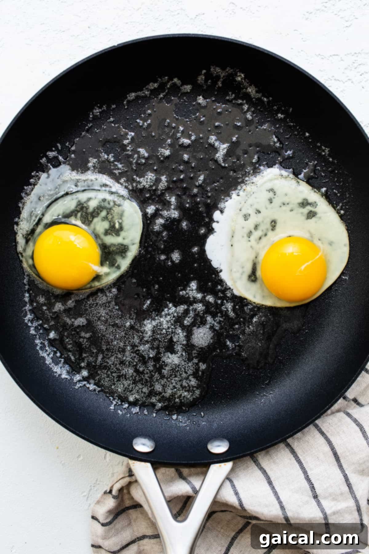 Liquid Gold Breakfast 4 Two over easy eggs sizzling in a hot skillet.