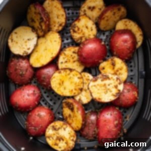 Roasted potatoes in an air fryer, golden and crispy.