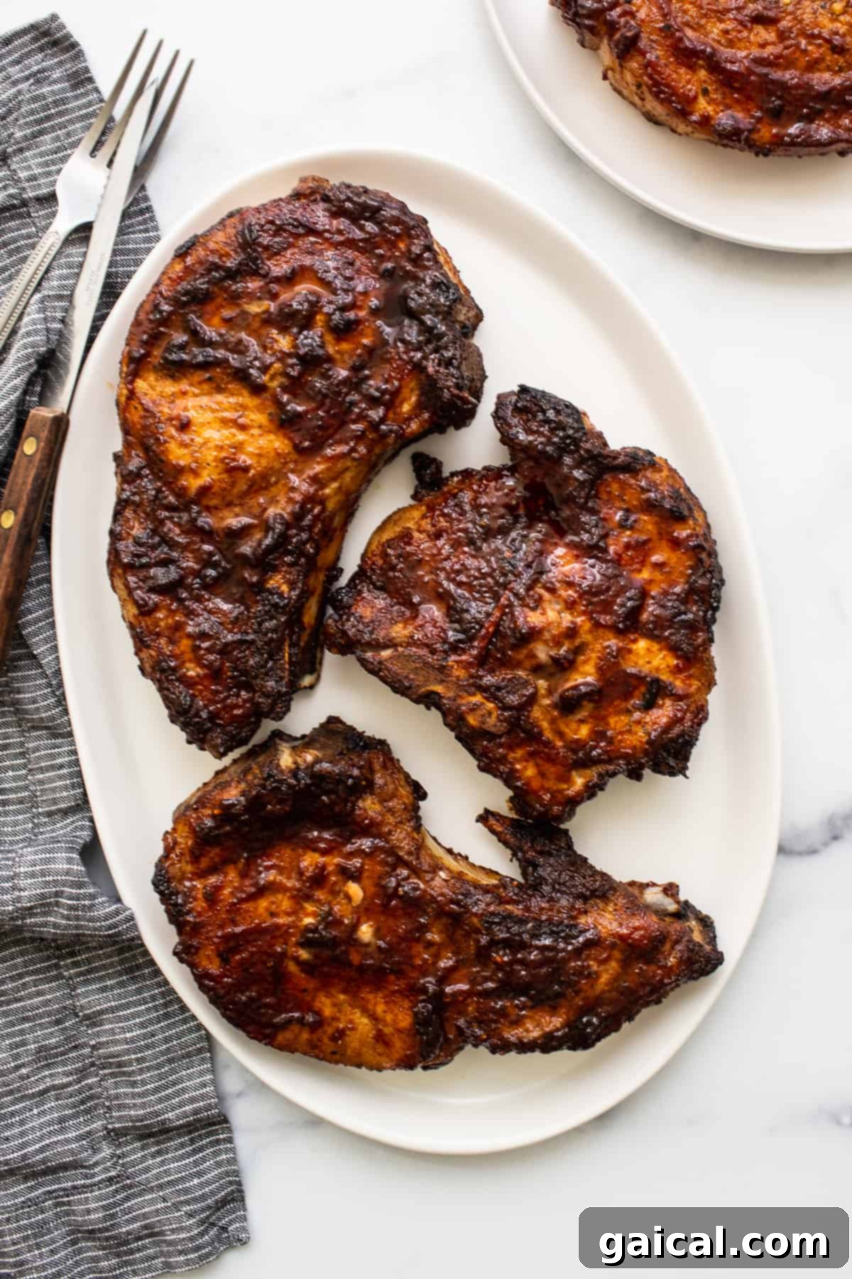 Juicy Air Fryer Pork Chops Recipe Perfectly cooked, juicy air fryer pork chops on a plate, ready to serve.