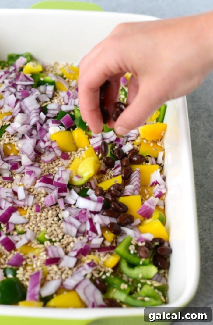 In just 60 minutes you can make this healthy chicken enchilada casserole that's packed with lean chicken, beans, tons of veggies, and brown rice. Throw everything into a casserole dish uncooked (that's right...UNCOOKED) and you've got yourself dinner for the entire family.