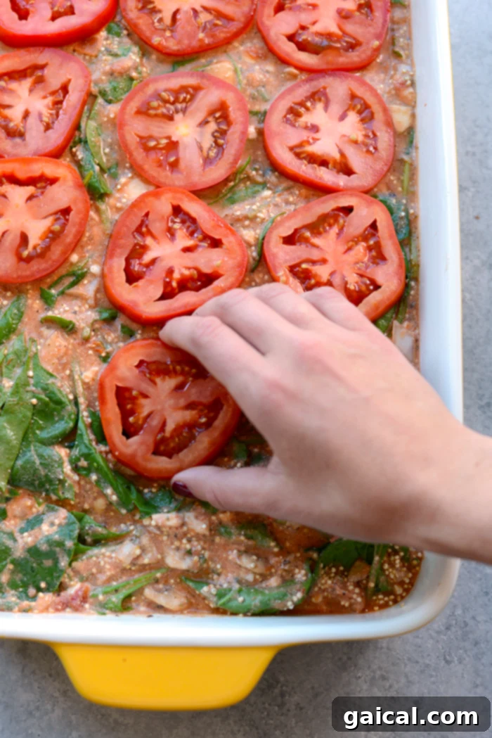 A close-up of the delicious layers of the Spinach Quinoa Lasagna Casserole, fresh out of the oven.