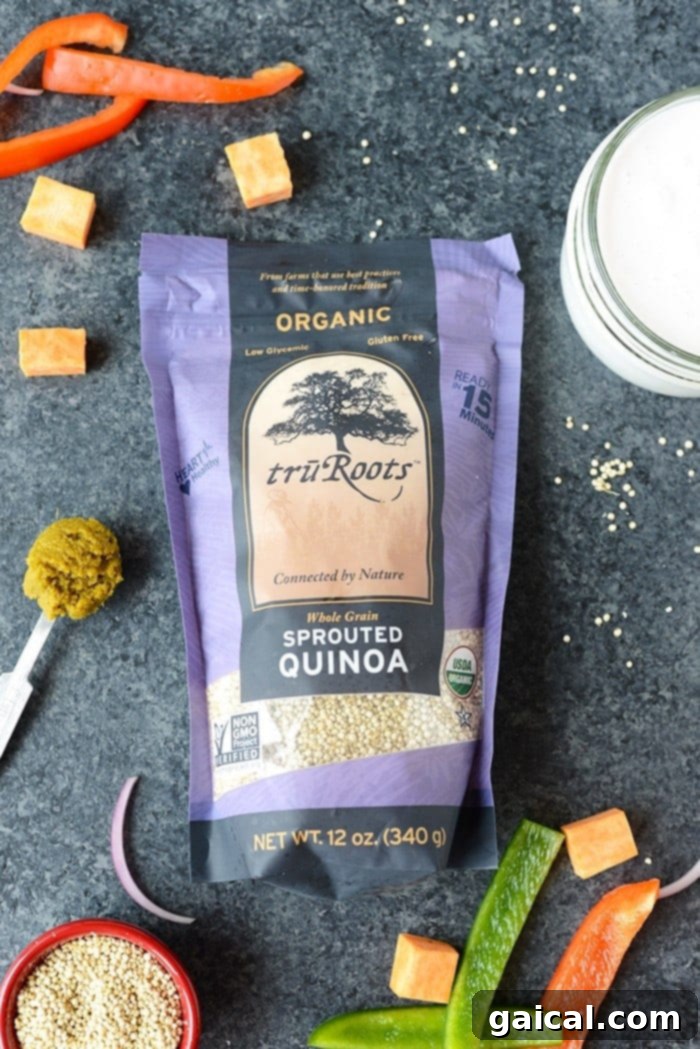 A serving of Sweet Potato Green Curry Quinoa Casserole topped with fresh herbs and toasted nuts in a bowl.