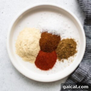 A small bowl holding a vibrant blend of dry spices, perfectly mixed for seasoning.