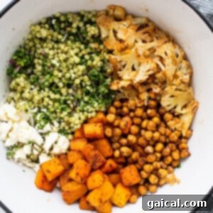 A vibrant mix of all the Israeli couscous salad ingredients beautifully tossed in a large serving bowl.