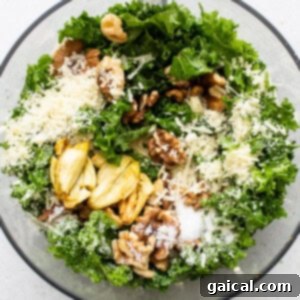 All of the ingredients for vibrant kale pesto loaded into a food processor, ready for blending.