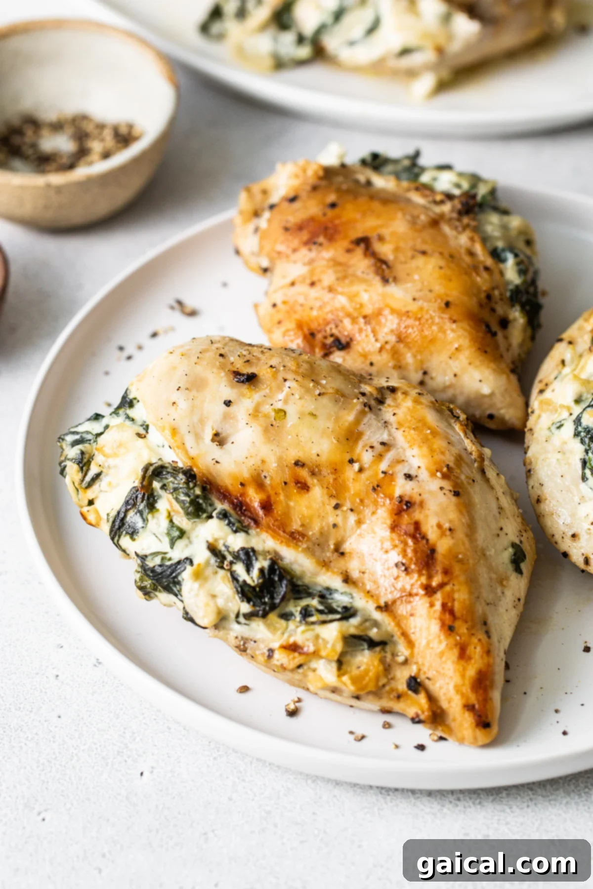 Delicious Spinach Stuffed Chicken Breast Recipe Spinach stuffed chicken breast on a plate, showcasing the cheesy filling.