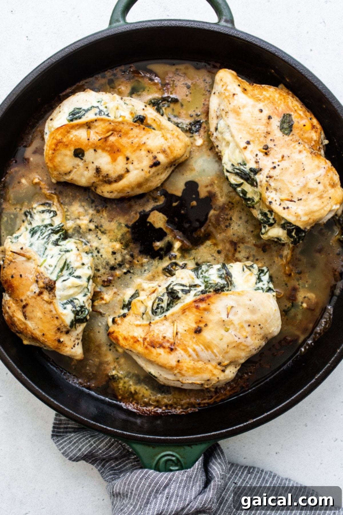 Searing Stuffed Chicken Breasts Stuffed chicken breast cooking in a hot skillet, achieving a golden sear.