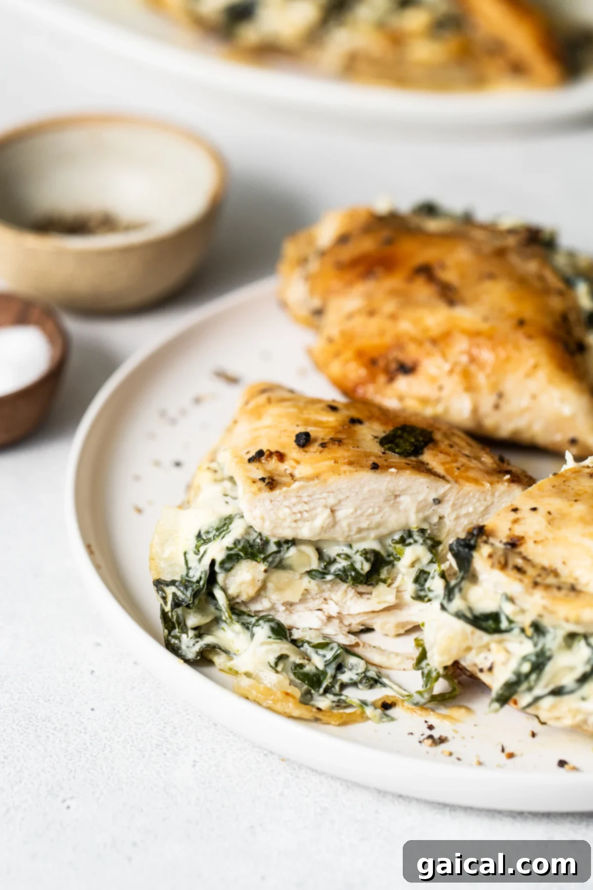 Spinach Stuffed Chicken Breast Plated Spinach stuffed chicken breast, beautifully plated and ready to serve.