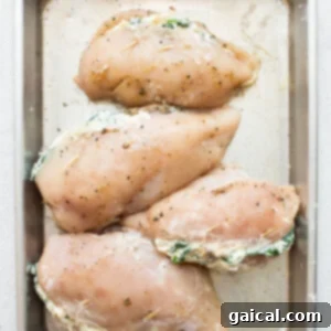 Cheesy Spinach Stuffed Chicken 12 Chicken breasts stuffed with spinach and cream cheese in a baking pan.