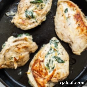 Cheesy Spinach Stuffed Chicken 13 Stuffed chicken breasts searing in a skillet, developing a crispy crust.