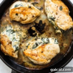 Cheesy Spinach Stuffed Chicken 14 Spinach stuffed chicken breasts baking in an oven-safe skillet.