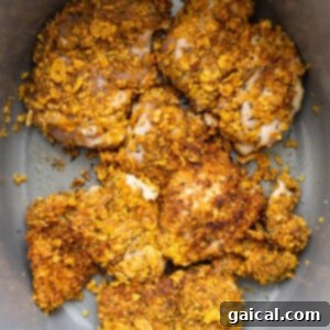 Breaded chicken searing in a hot skillet.