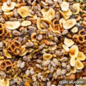 A bowl of mixed nuts and seeds with a wooden spoon.