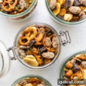 Four jars filled with nuts, seeds, and dried fruit.