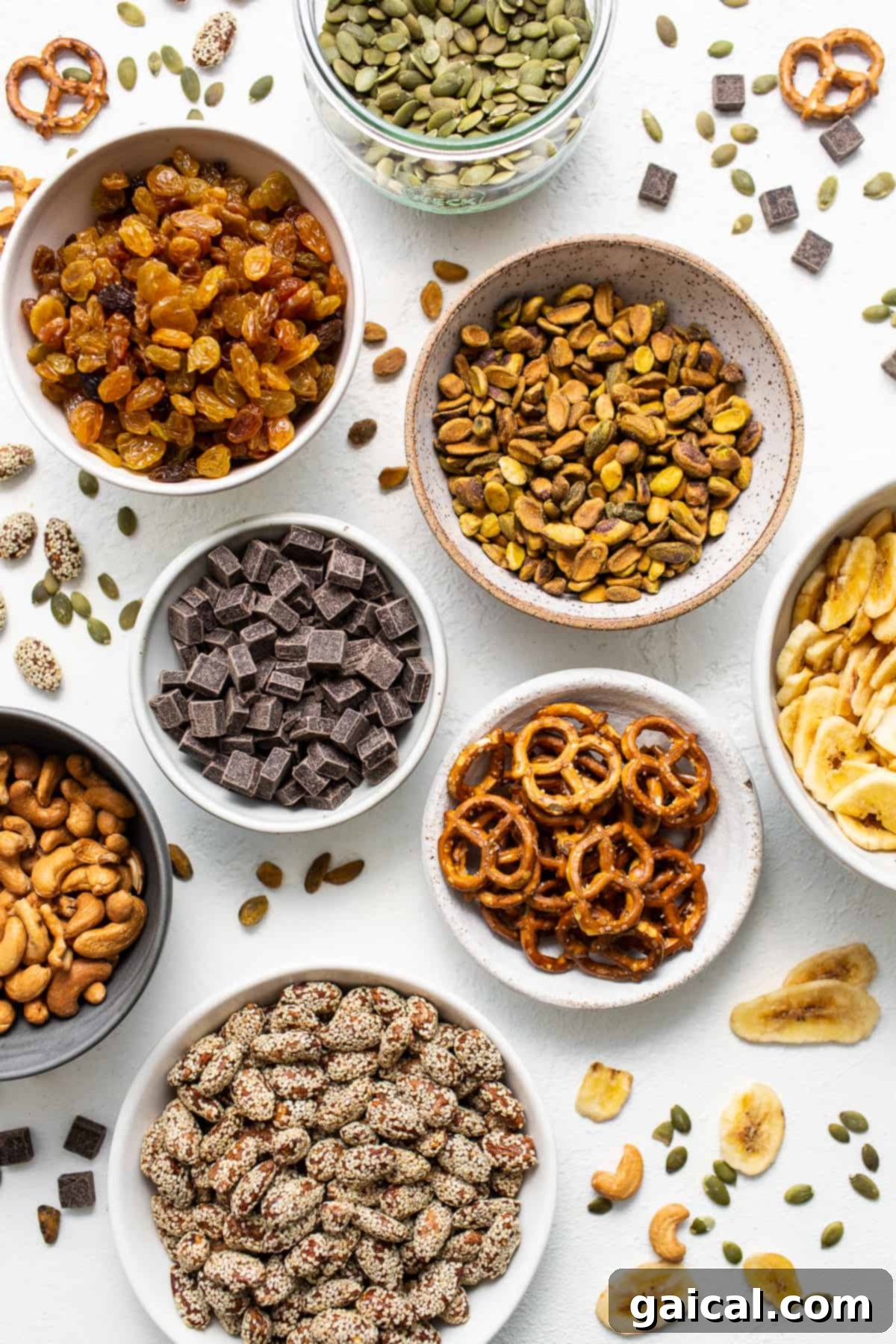 This healthy homemade trail mix is the perfect snack to satisfy all your sweet and salty cravings. Homemade trail mix ingredients in bowls.