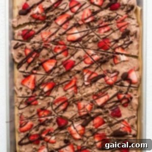 Swirled Strawberry Chocolate Yogurt Bark 6 A sheet of chocolate covered strawberries on a baking sheet.