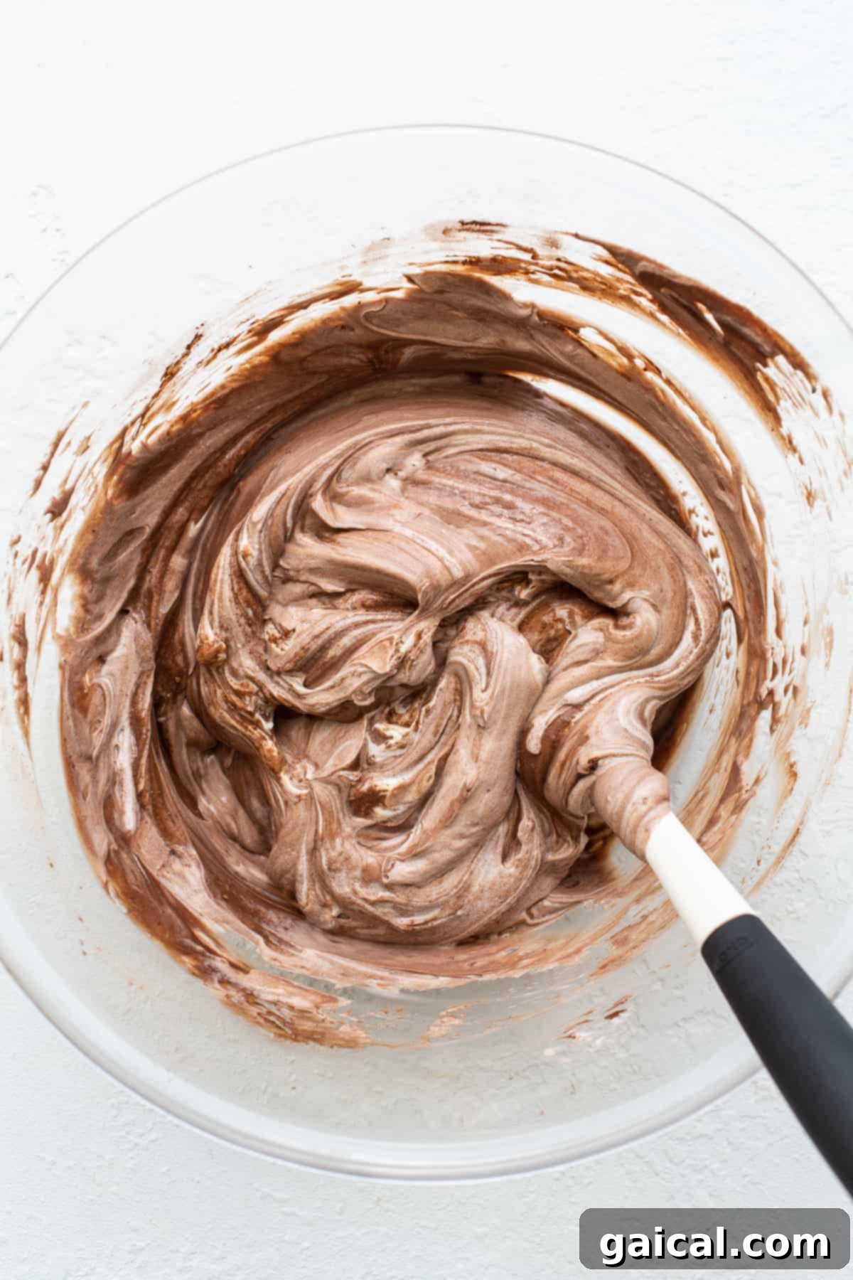Mixing the yogurt bark base Frozen yogurt bark ingredients mixed together in a bowl.