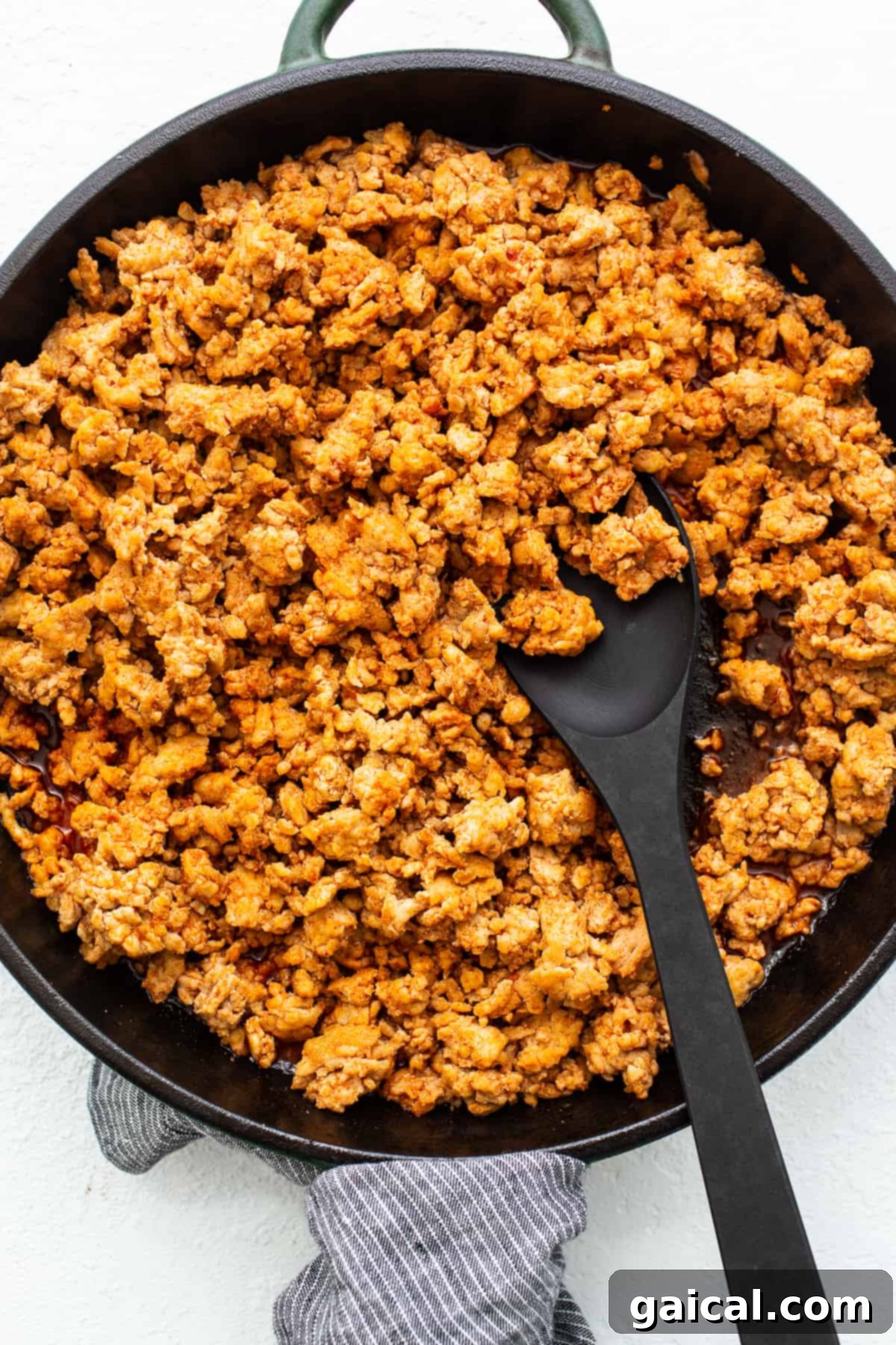 Spicy Korean Ground Chicken Bowls 6 A spoonful of richly sauced ground chicken, highlighting its tender texture and vibrant gochujang coating.