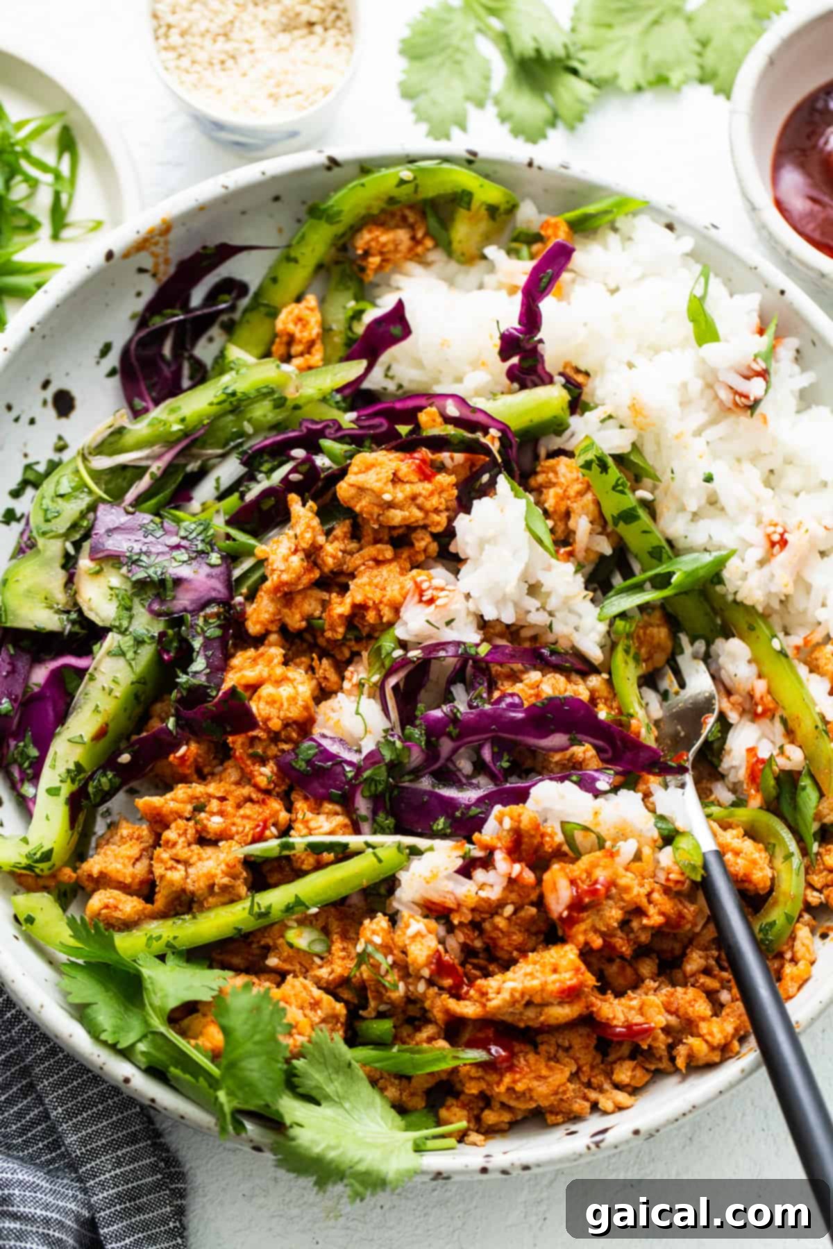 Spicy Korean Ground Chicken Bowls 8 Two ground chicken bowls garnished with fresh cilantro and green onions, presented beautifully for a healthy meal.