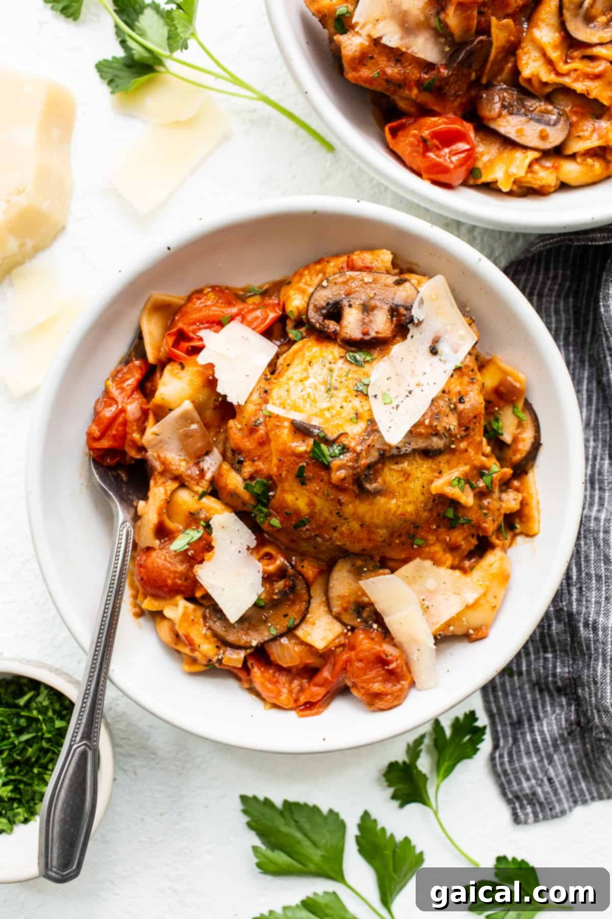 A comforting bowl of pappardelle pasta with tender chicken. Close-up of pappardelle with chicken thighs in a bowl, showcasing the rich sauce and tender ingredients.