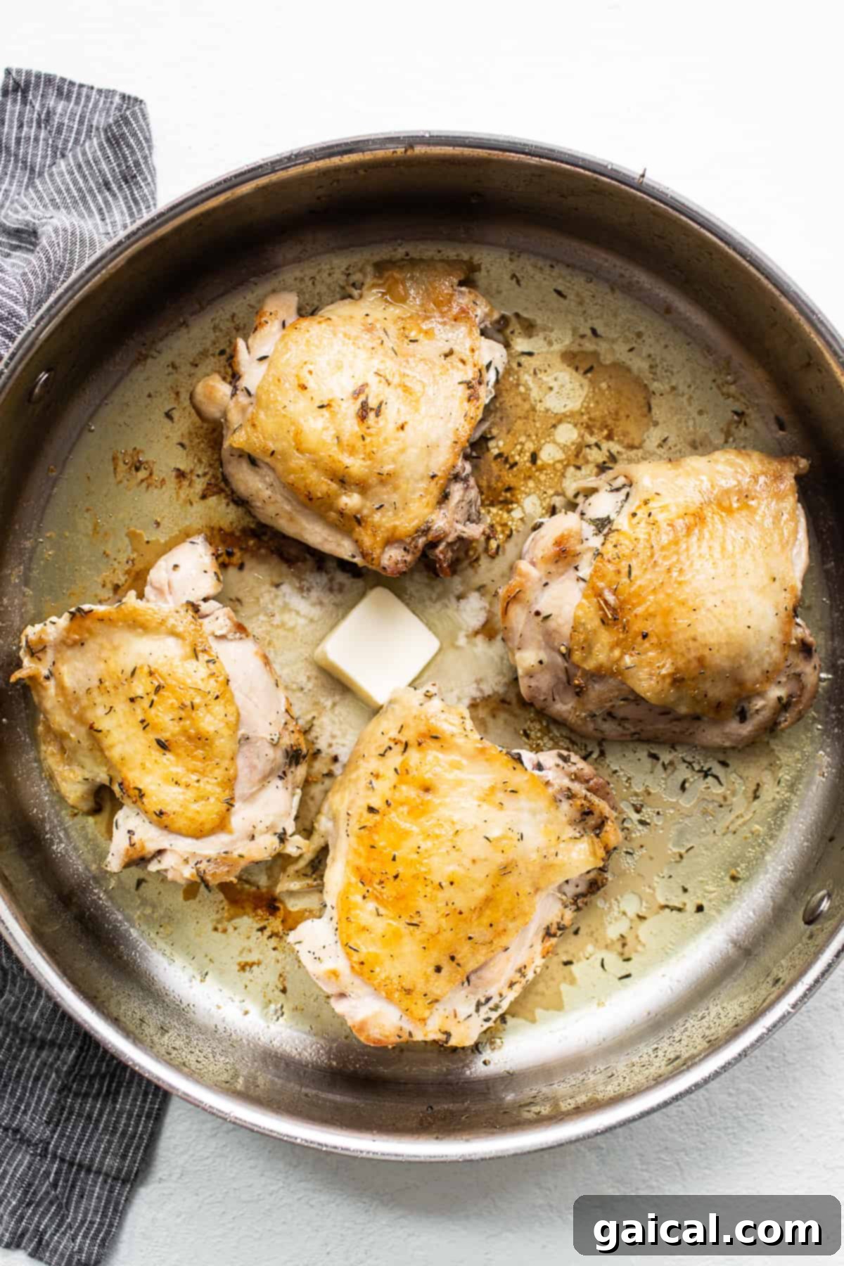 Searing chicken thighs to develop deep flavor for a rich pasta sauce. Crispy-skinned chicken thighs searing in a large skillet, ready for the sauce.