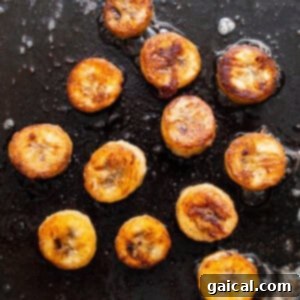 Caramelizing banana slices in a pan with butter and rum