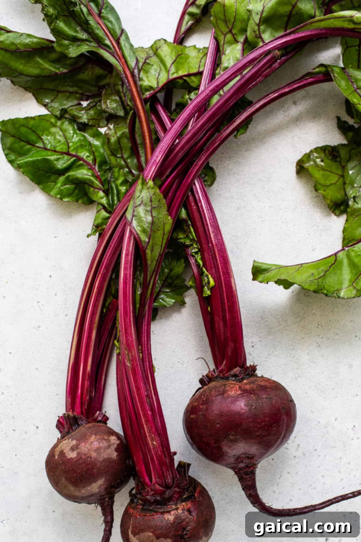 Unlocking the Flavor of Beets 3 Whole beets with their green leaves attached.