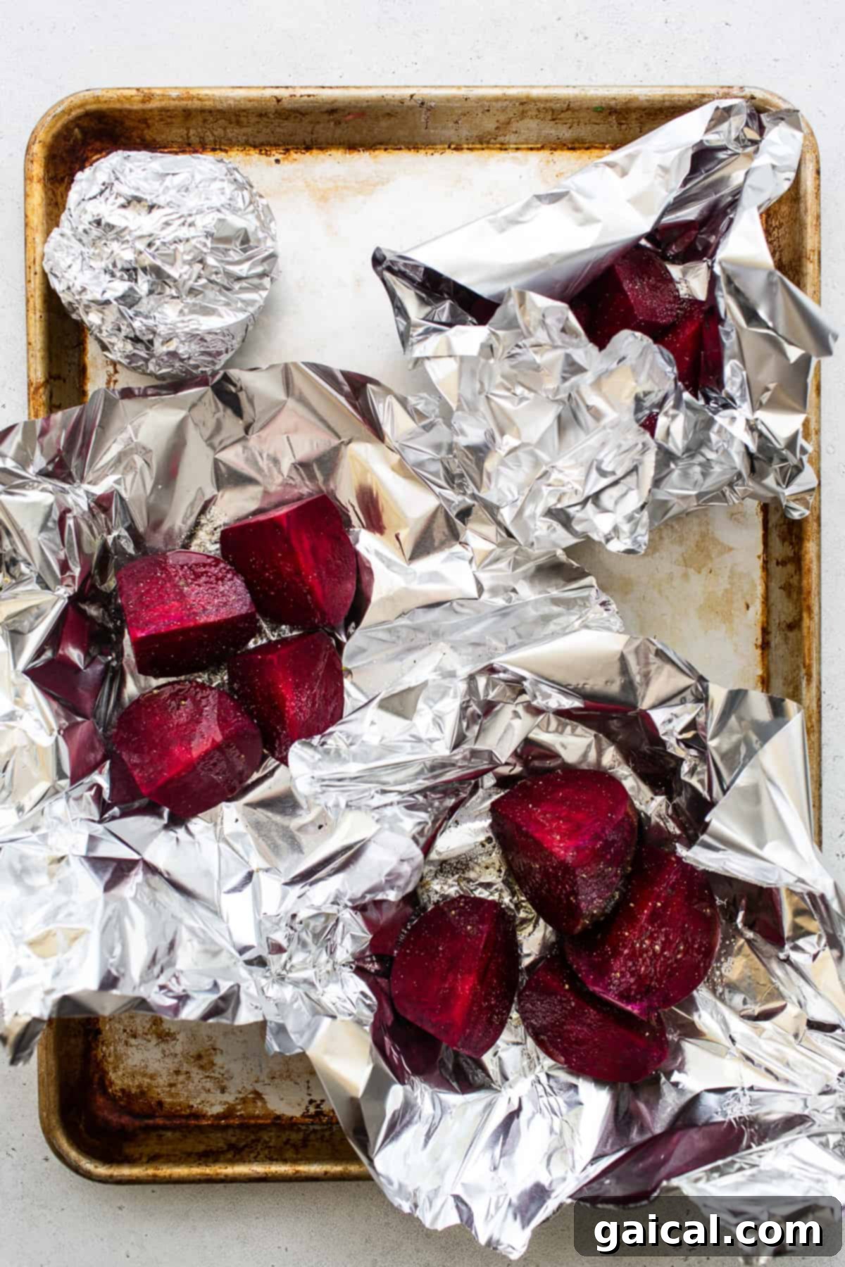 Unlocking the Flavor of Beets 5 Sliced beets being wrapped in tin foil for roasting.