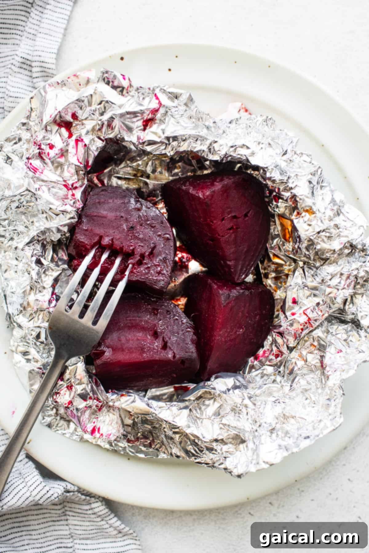 Unlocking the Flavor of Beets 7 Roasted beets with a fork inserted, showing their tenderness.