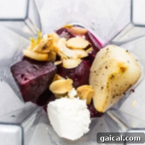 Roasted beets, garlic, and onion in a blender, ready to be pureed into sauce.