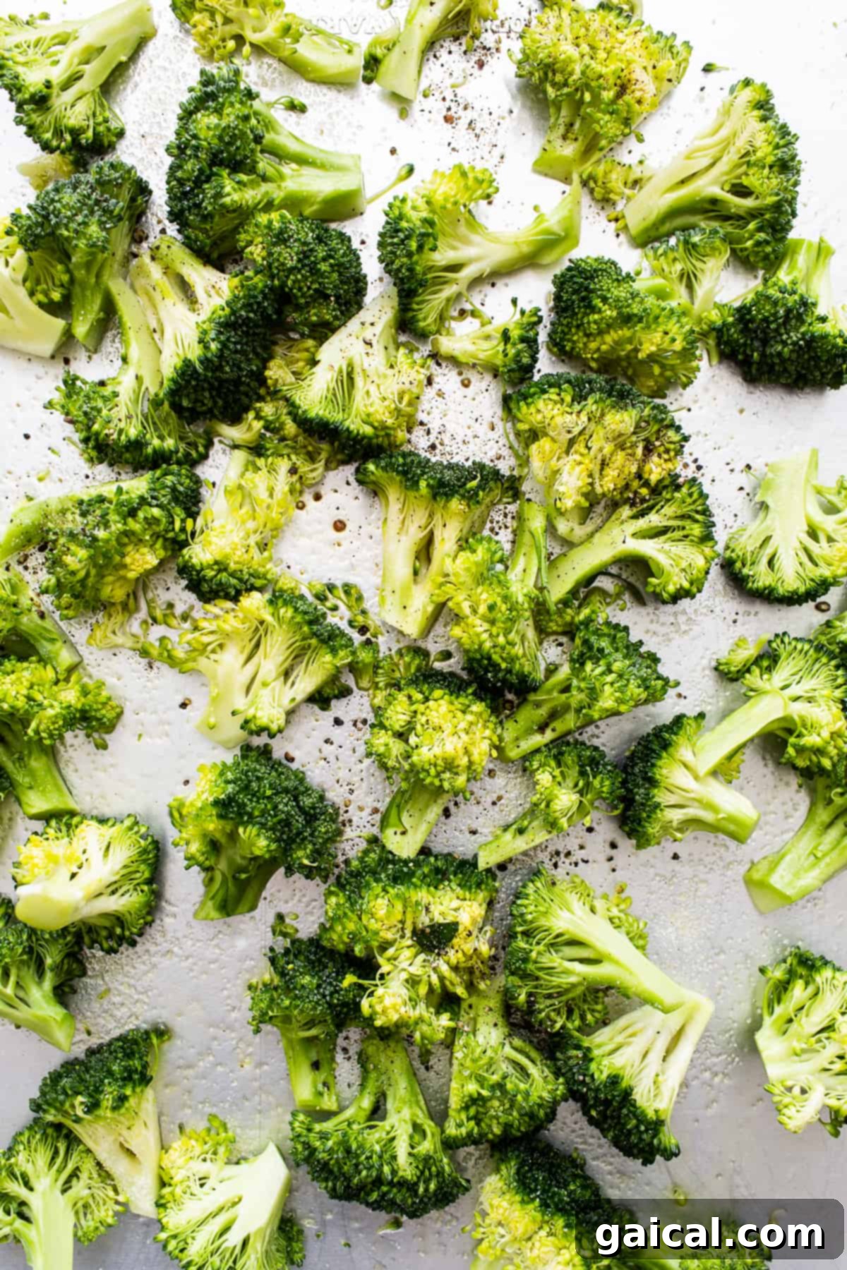 Roasted Broccoli on Sheet Pan Crispy, golden-brown roasted broccoli florets spread out on a sheet pan, just removed from the oven.