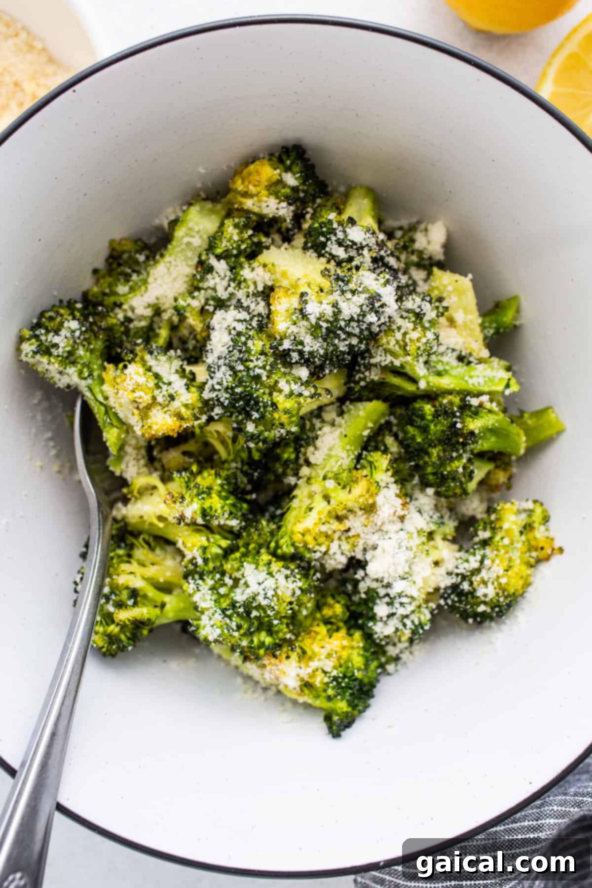Parmesan Roasted Broccoli A serving of roasted broccoli generously topped with grated Parmesan cheese, ready to be savored.
