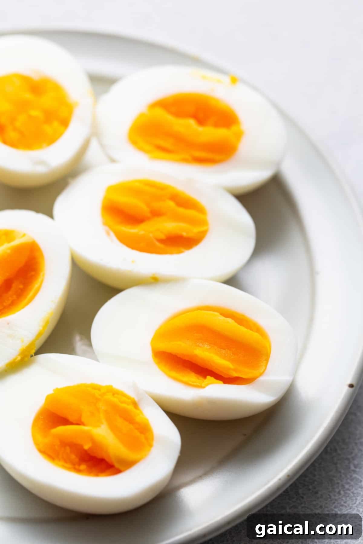 Air Fryer Hard Boiled Eggs: Your New Favorite Method for Easy Cooking Perfectly cooked air fryer hard boiled eggs, freshly peeled and served on a pristine white plate, garnished with a sprinkle of herbs.