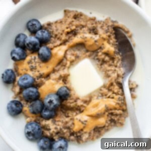 A perfectly prepared bowl of porridge topped with vibrant berries and creamy nut butter.