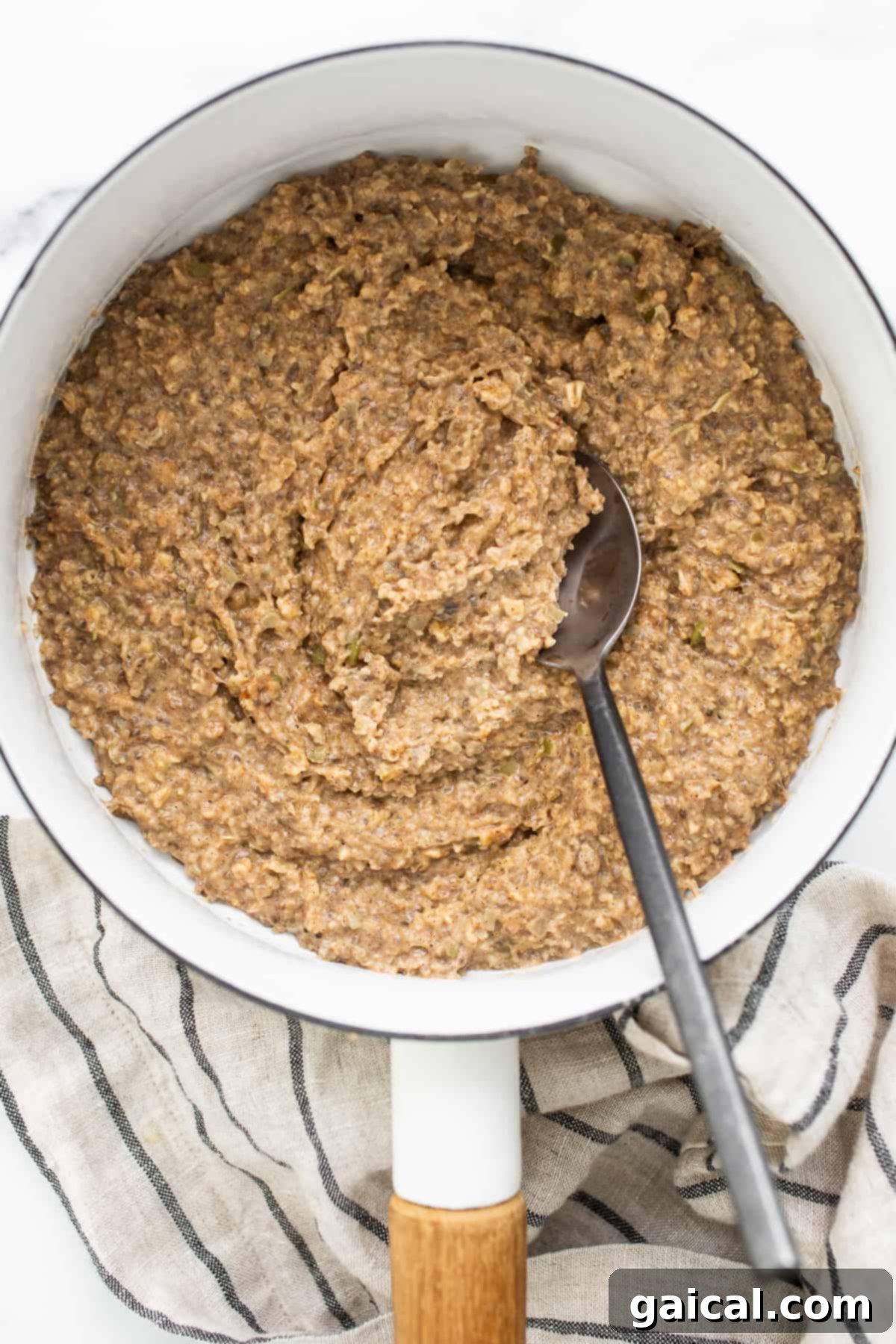 Sunrise Comfort Bowl 6 Creamy porridge simmering gently in a saucepan on the stovetop.