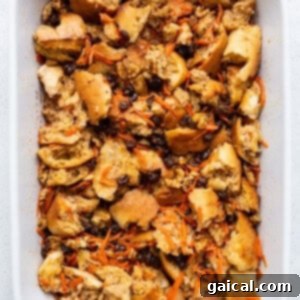 A white baking dish filled with bread and carrots.