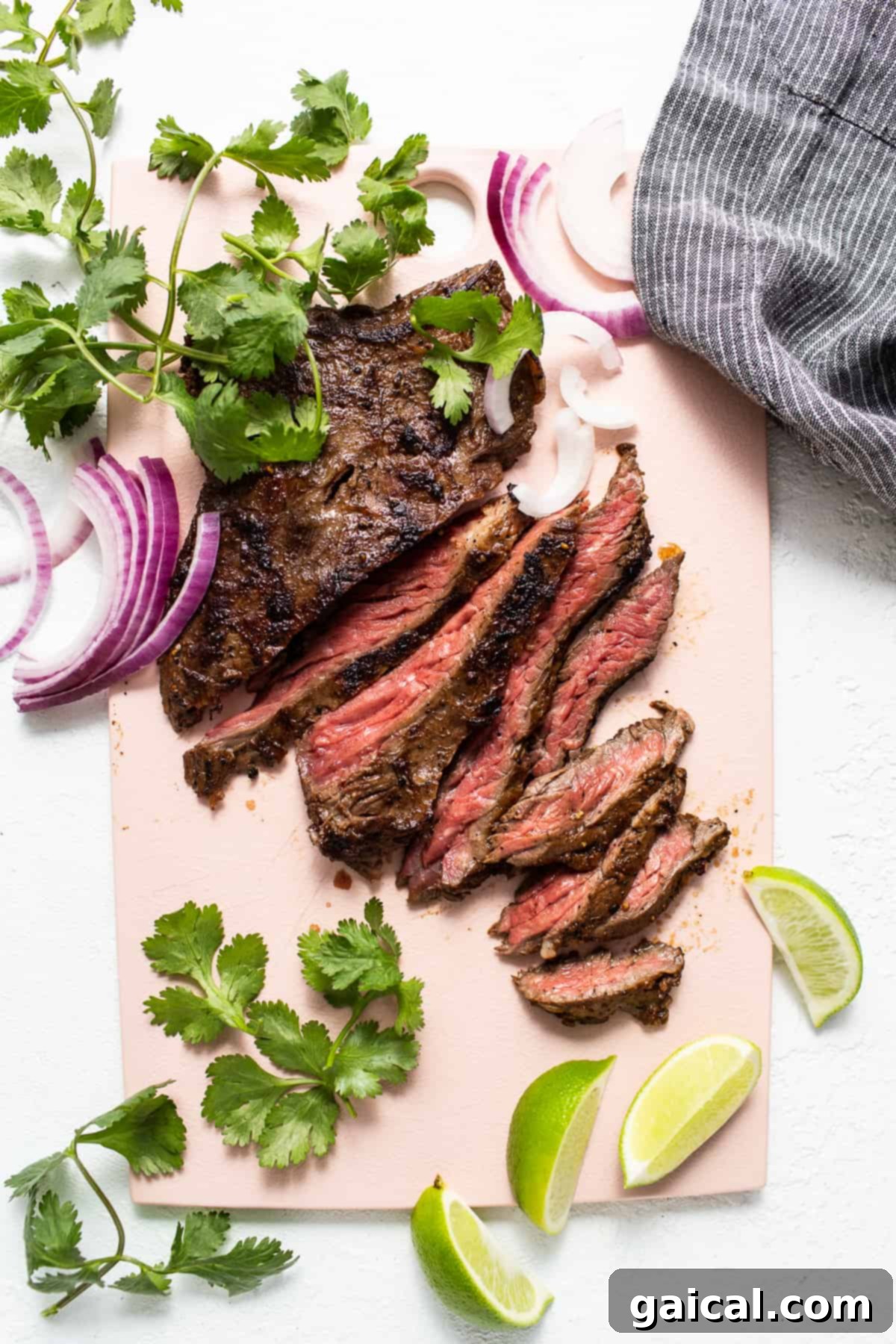 Mastering Skirt Steak Cooking 6 Perfectly sliced pan-seared skirt steak, showcasing its juicy interior, arranged on a cutting board, ready to be served.