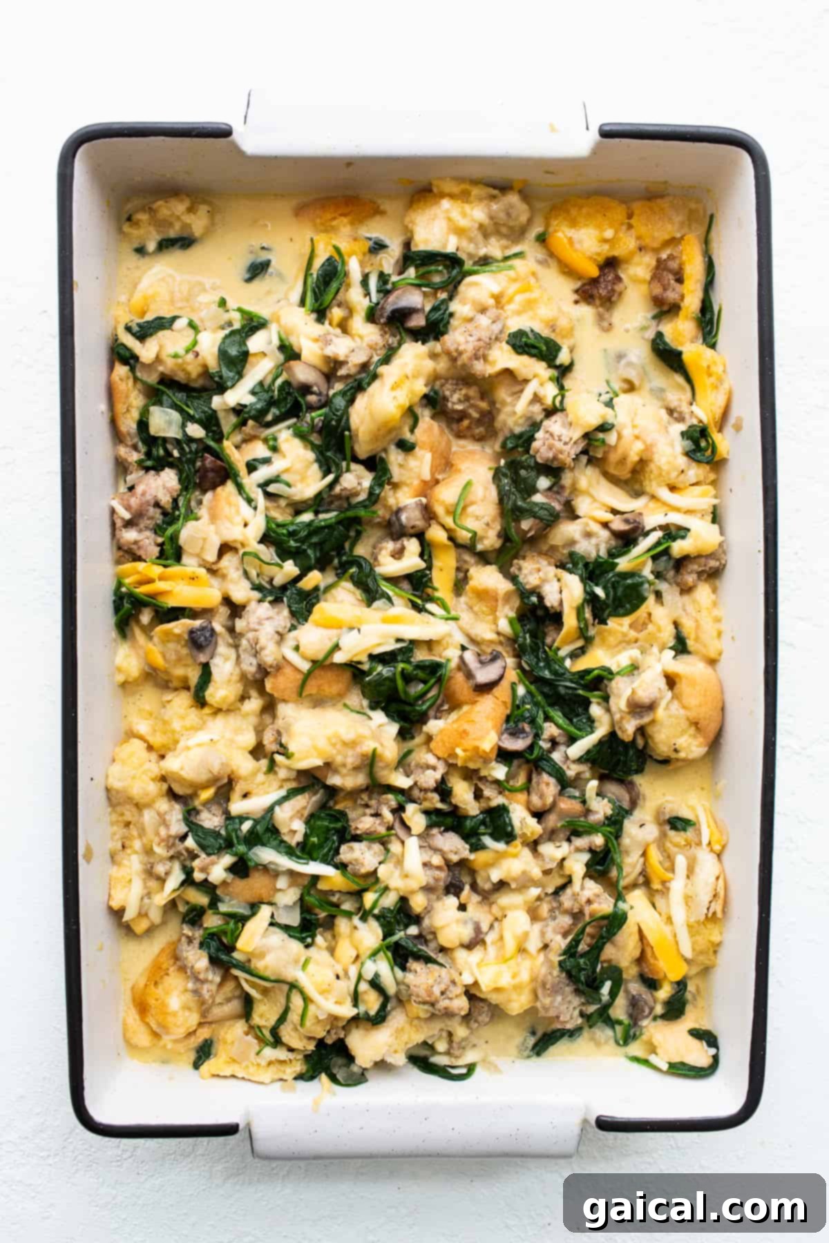 Overnight Strata Ready to Bake Breakfast strata after it soaked overnight in a casserole dish, highlighting its ready-to-bake state.