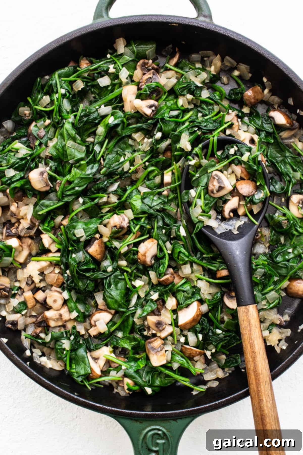 Freshly Sautéed Vegetables for Strata A pan filled with beautifully sautéed spinach and other aromatic vegetables, ready for the strata.