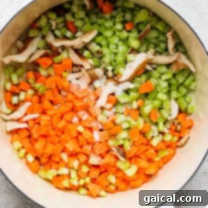 Hearty Ham and Split Pea Soup 11 A pot with carrots, celery and mushrooms in it.