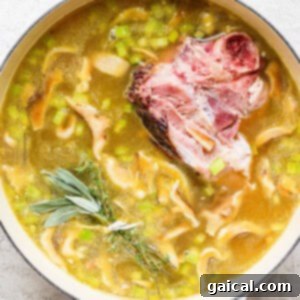 Hearty Ham and Split Pea Soup 13 A pot of soup with meat, peas and sprigs of rosemary.